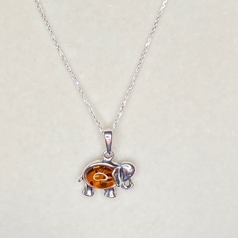 Museum Quality Amber elephant pendant on 18” Italian silver chain.